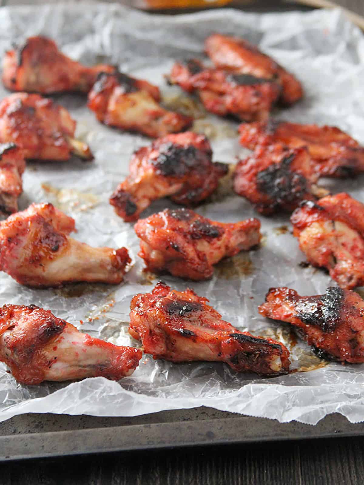 baked wings with honey and shrimp paste flavor on a baking sheet.