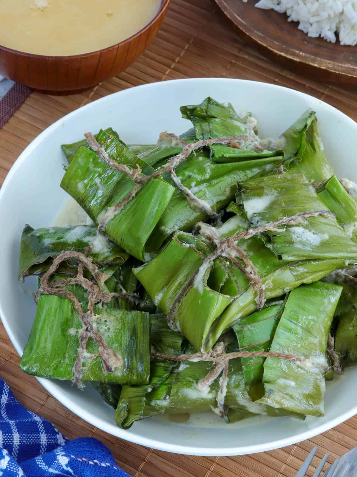 pinais na hipon in banana leaves in a white serving bowl.