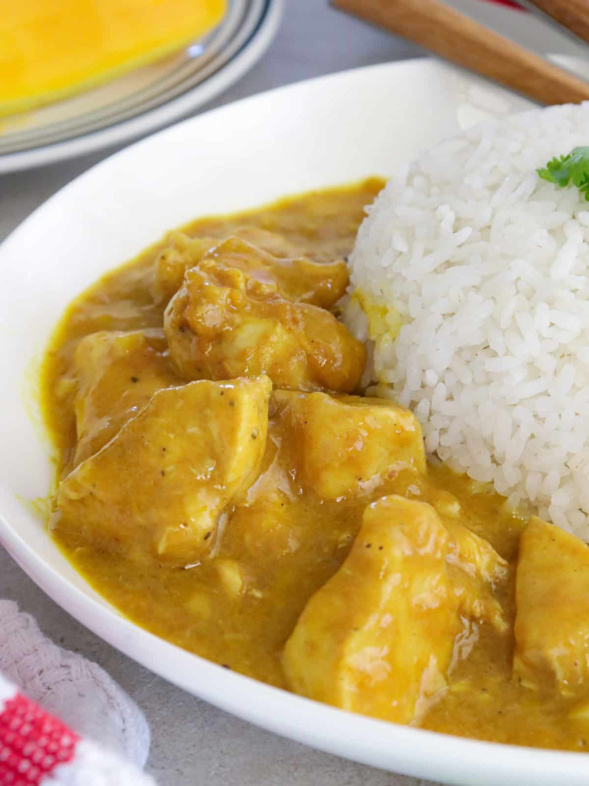 Mango Curry Chicken with steamed rice on a white plate.