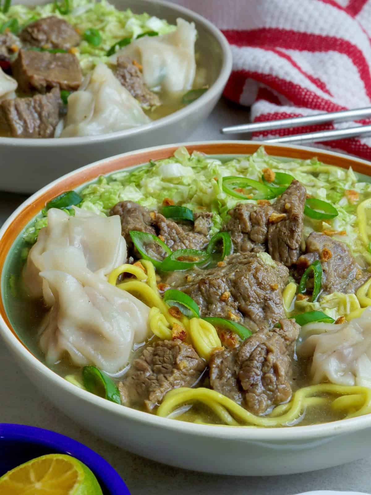 beef mami soup in a white bowl.