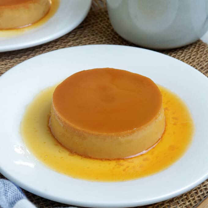 caramel flan on white plate.