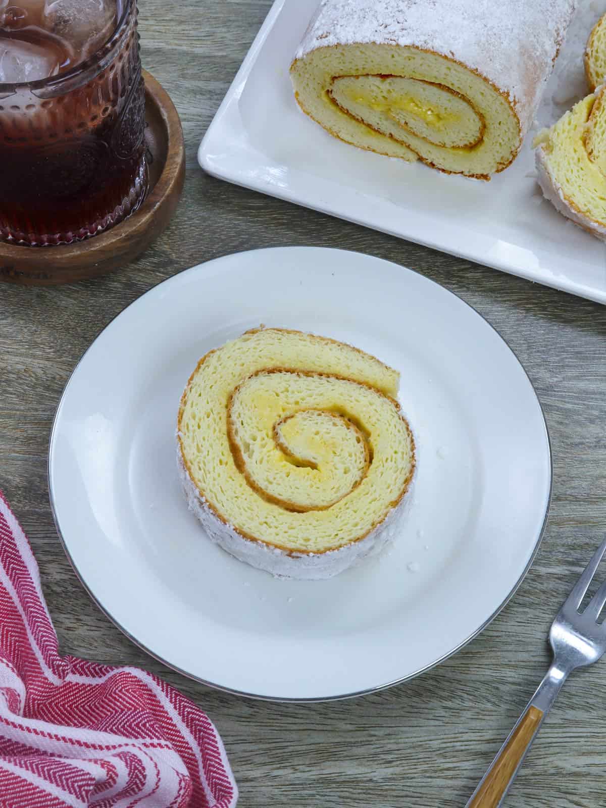 sliced Filipino jelly roll on a white plate.