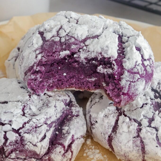 bitten Ube Crinkles on parchment-lined plate.