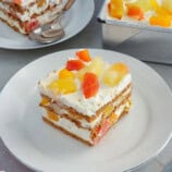 slice of no-bake fruit cocktail graham cake on a white plate.