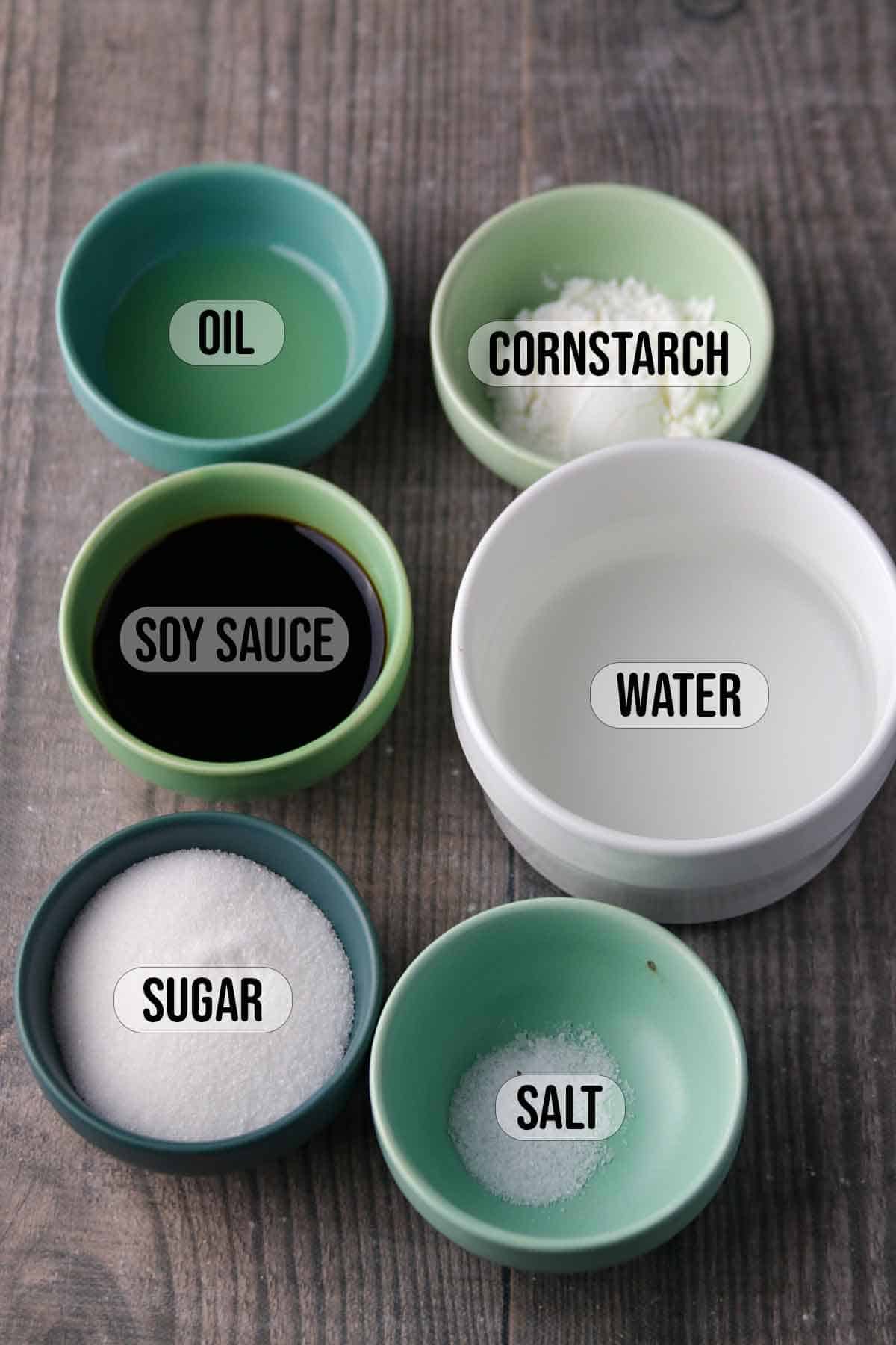 soy sauce, sugar, cornstarch, oil, water, salt in bowls.