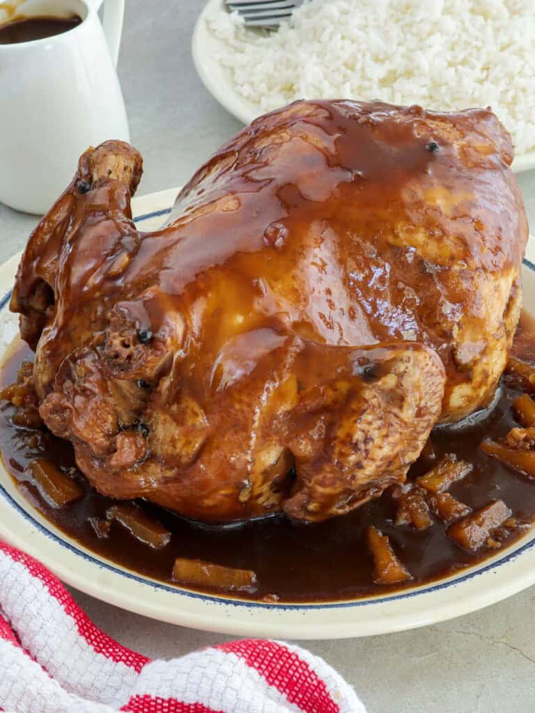 Tiniim na Manok on a serving platter with pineapple tidbits garnish.