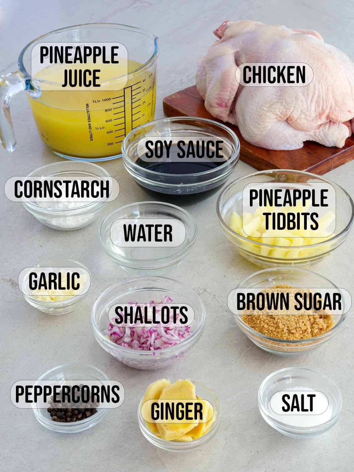 whole chicken, pineapples, sugar, salt, ginger, soy sauce, garlic, cornstarch, peppercorns, water in bowls.