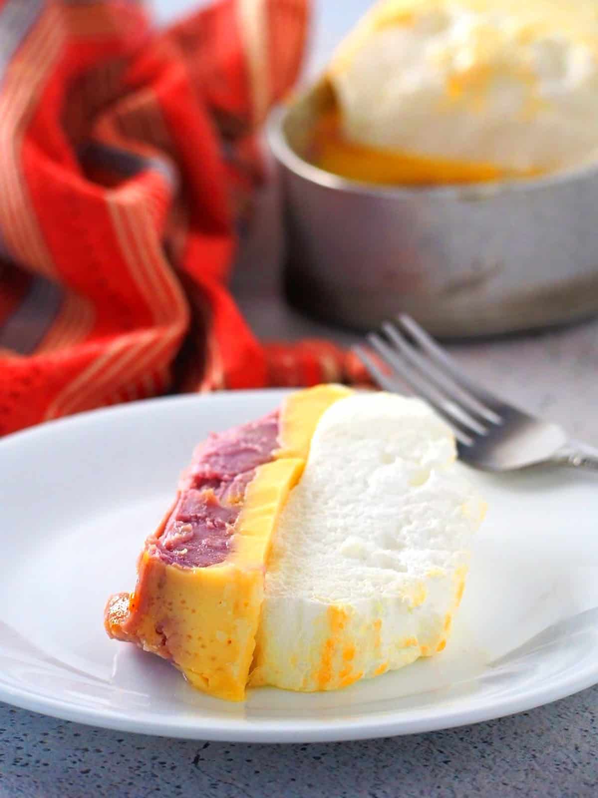 slice of 3-in-1 floating island dessert on a white serving plate.