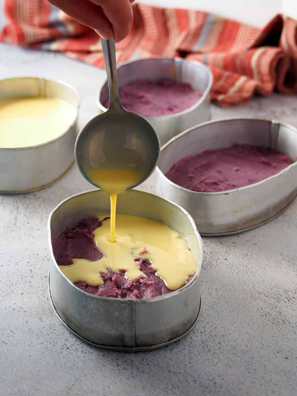 pouring leche flan mixture on ube layer layer to make floating island dessert.