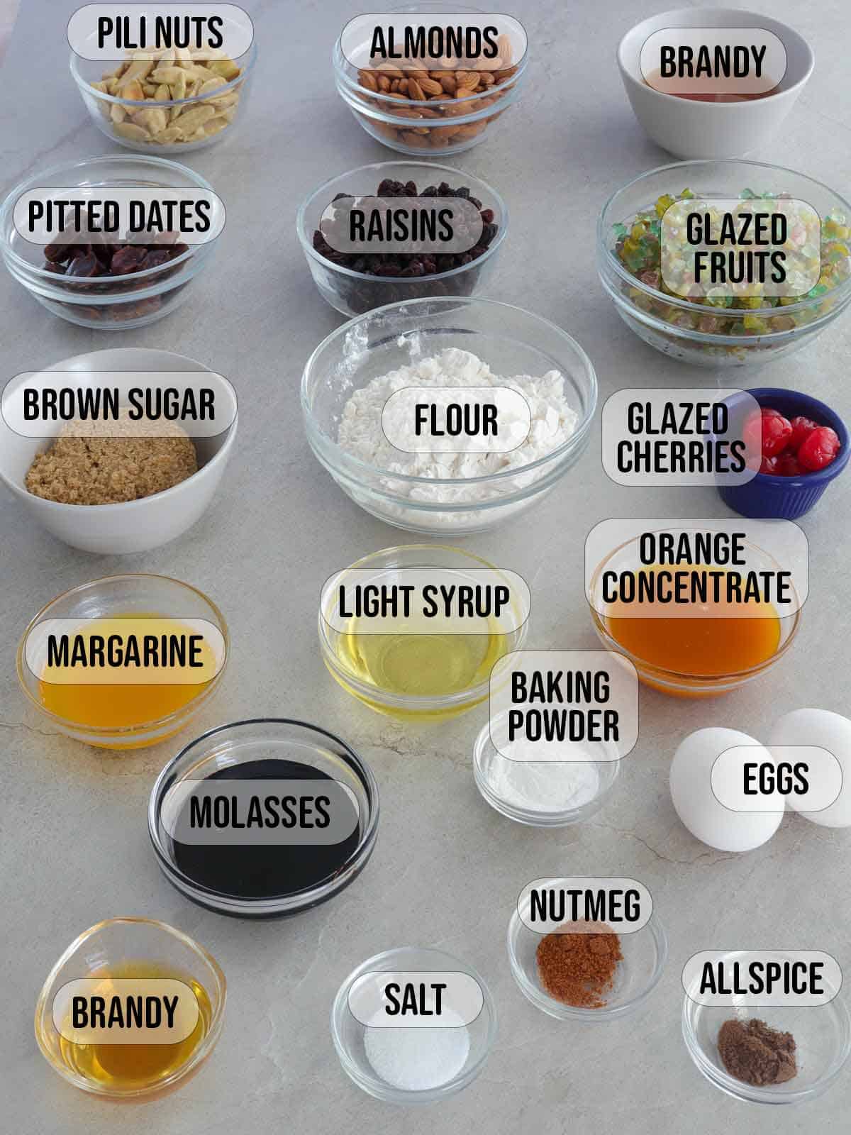 ingredients for fruitcake in bowls.