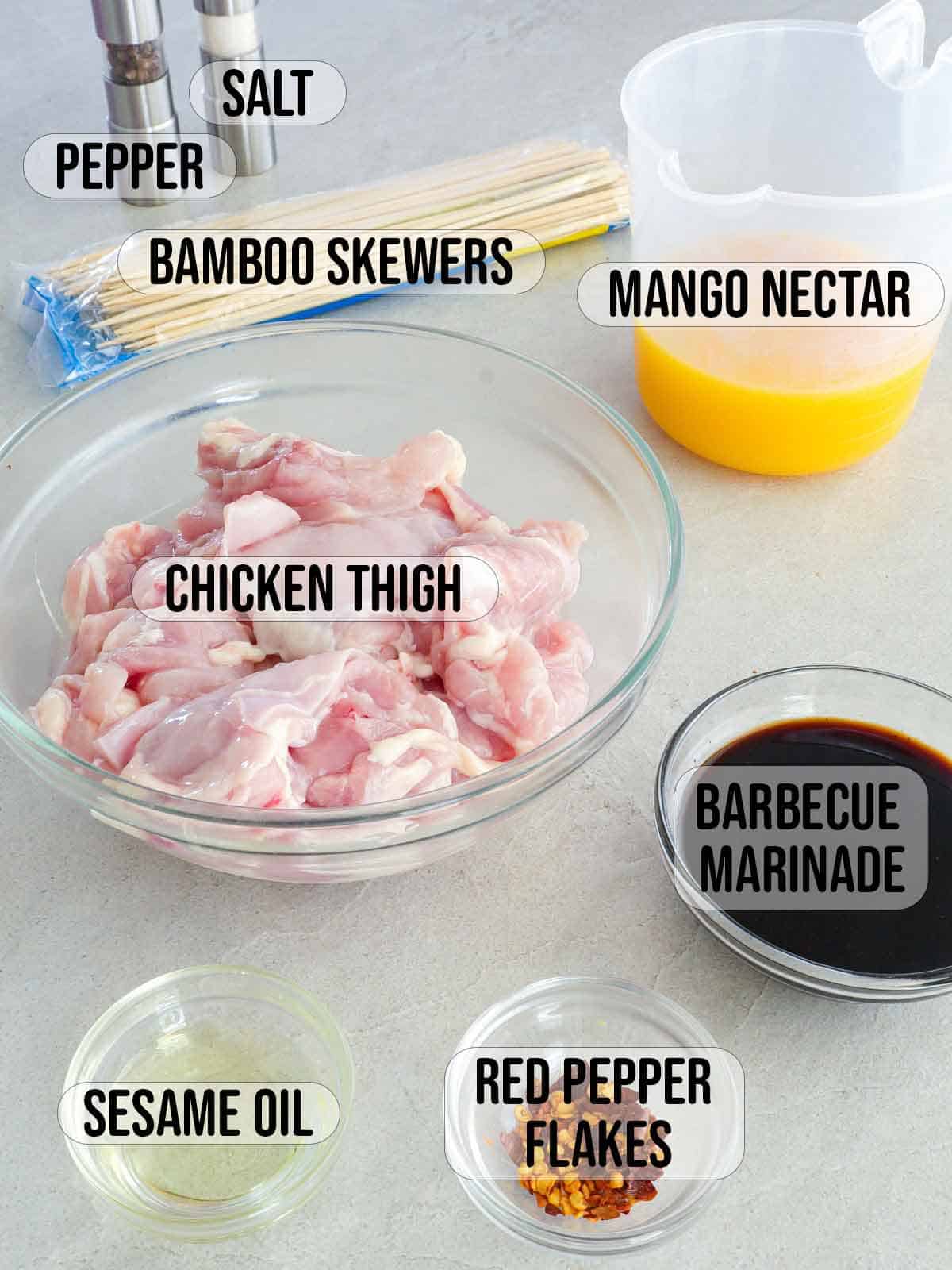 boneless chicken thighs, bbq marinade, bamboo skewers, sesame oil, mango nectar, red pepper flakes.