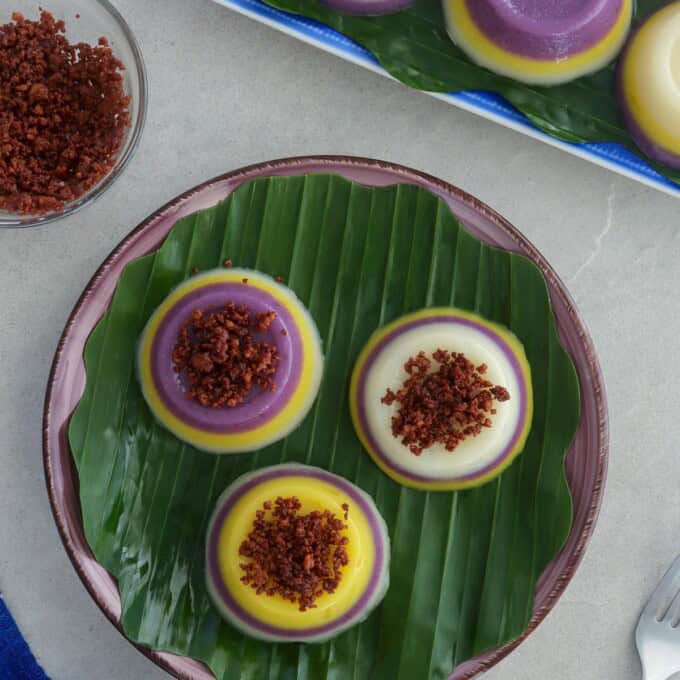 mini special sapin-sapin on a banana leaf-lined plate.