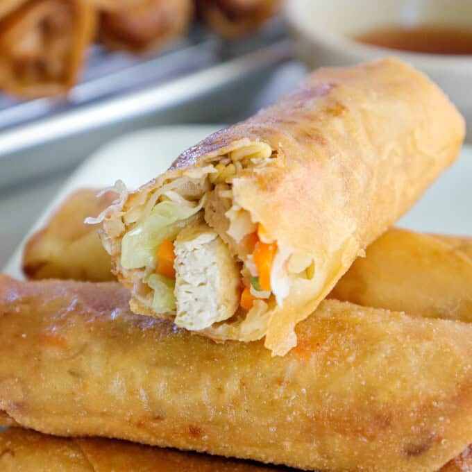 bitten lumpiang gulay on a white plate.