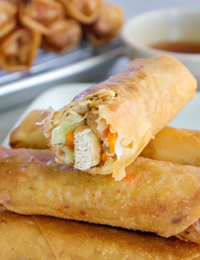 bitten lumpiang gulay on a white plate.