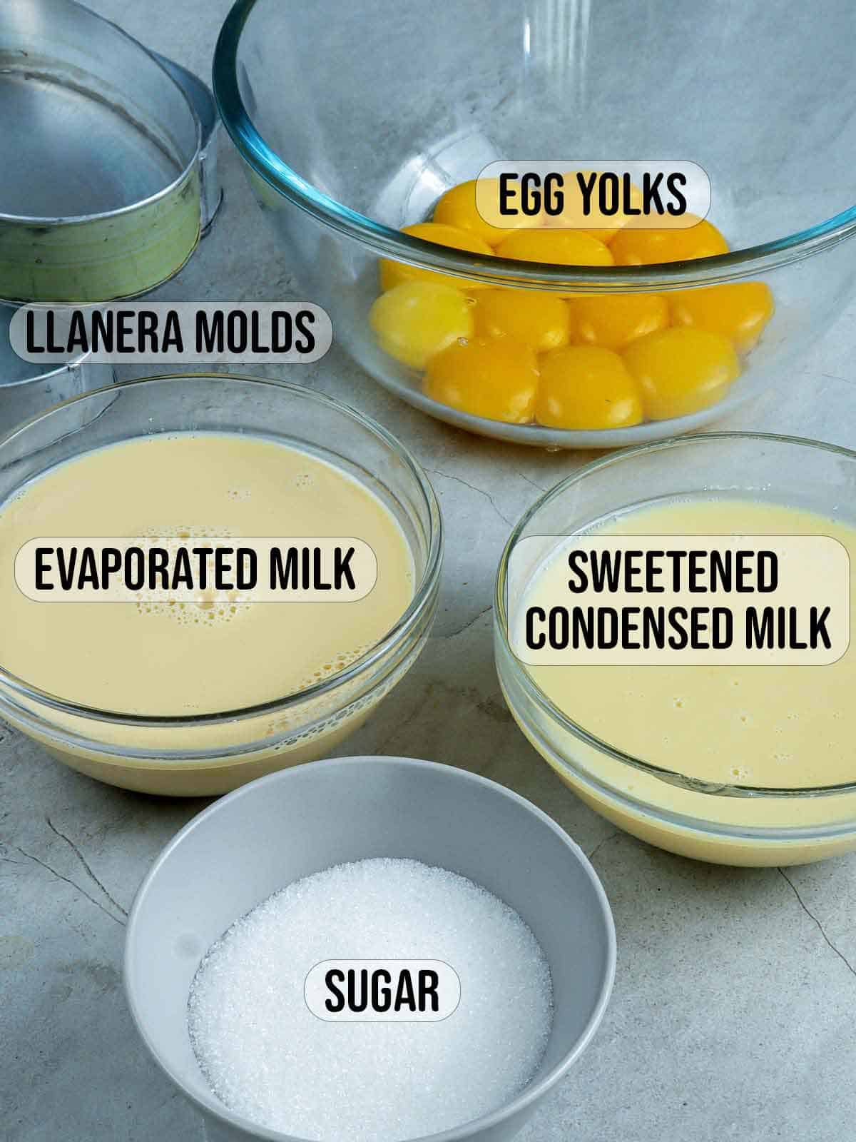 egg yolks, sugar, evaporated milk, condensed milk in bowls.