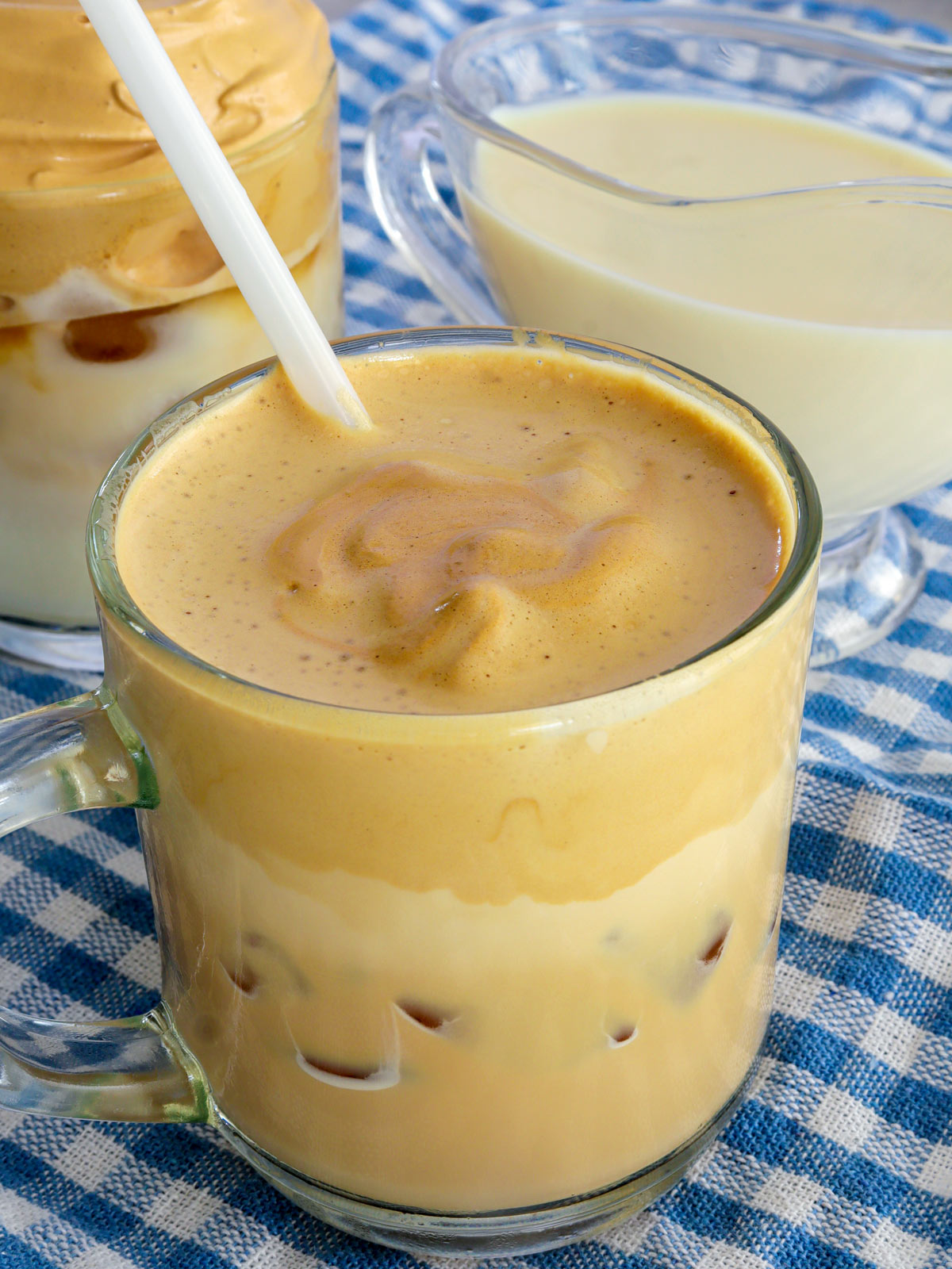 whipped coffee in a glass mug with straw.