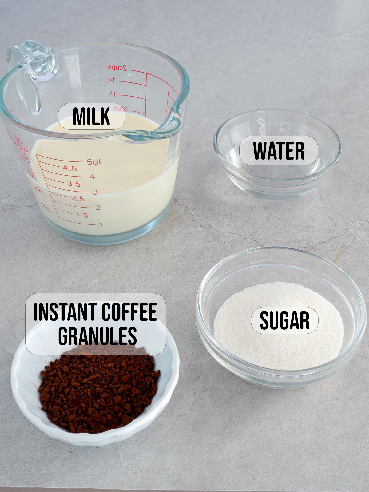 instant coffee granules, sugar, water, and milk in bowls.