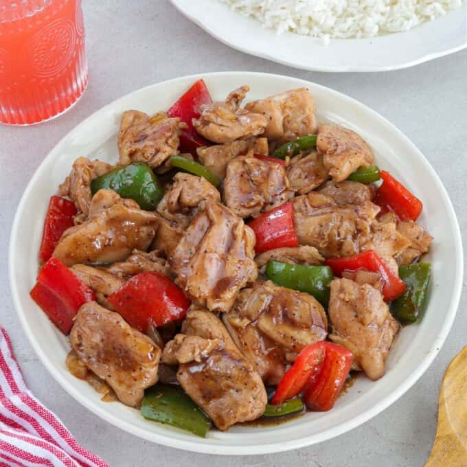 Chinese Black Pepper Chicken Stir-fry with bell peppers on a white serving platter.