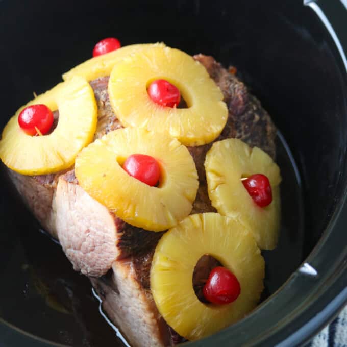 ham with pineapples and maraschino cherries cooked in the slow cooker.