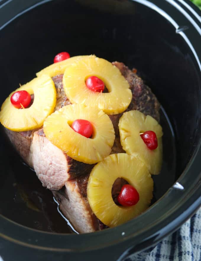 ham with pineapples and maraschino cherries cooked in the slow cooker.