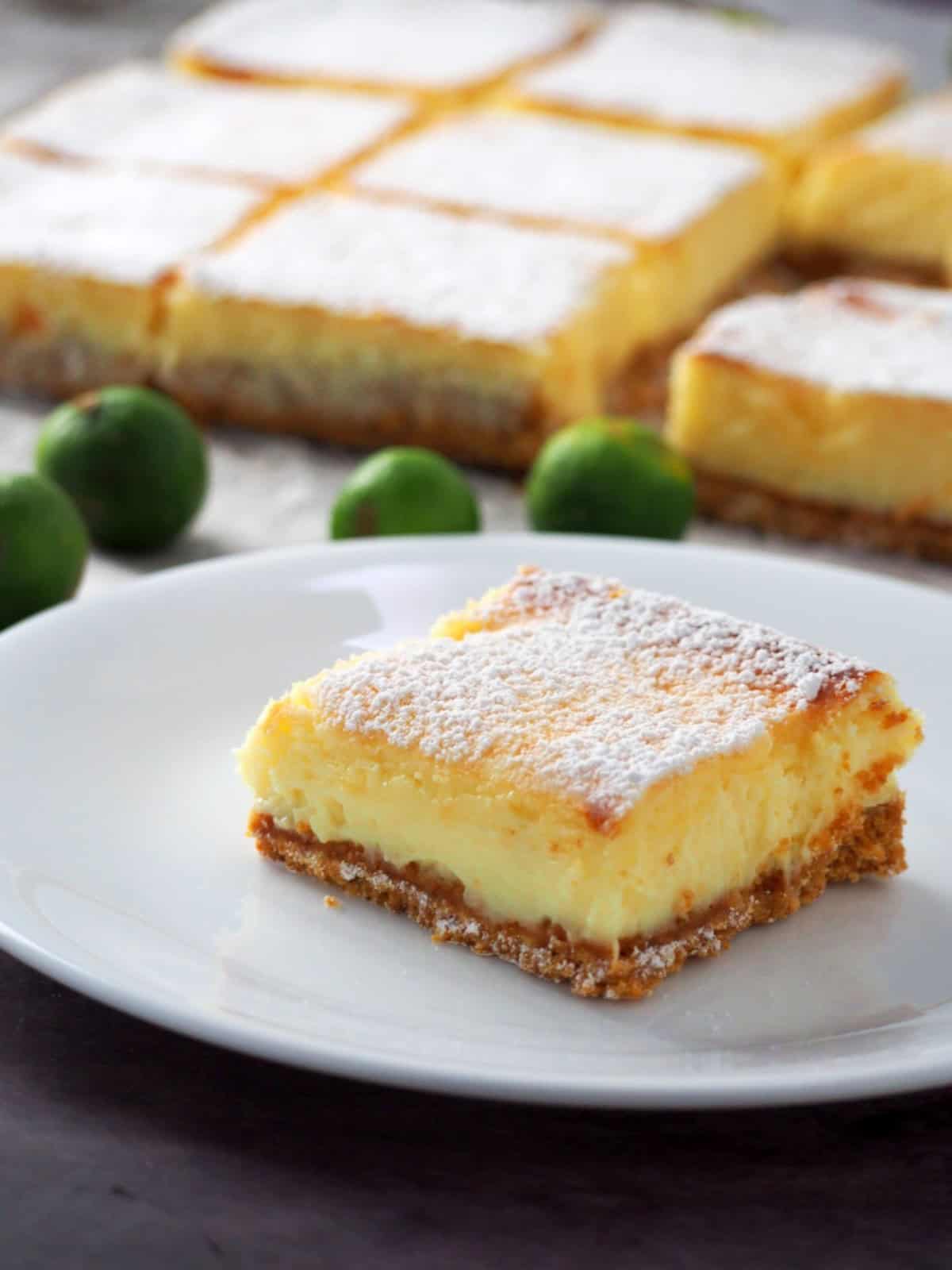 slice of calamansi cheesecake bar on a white plate.