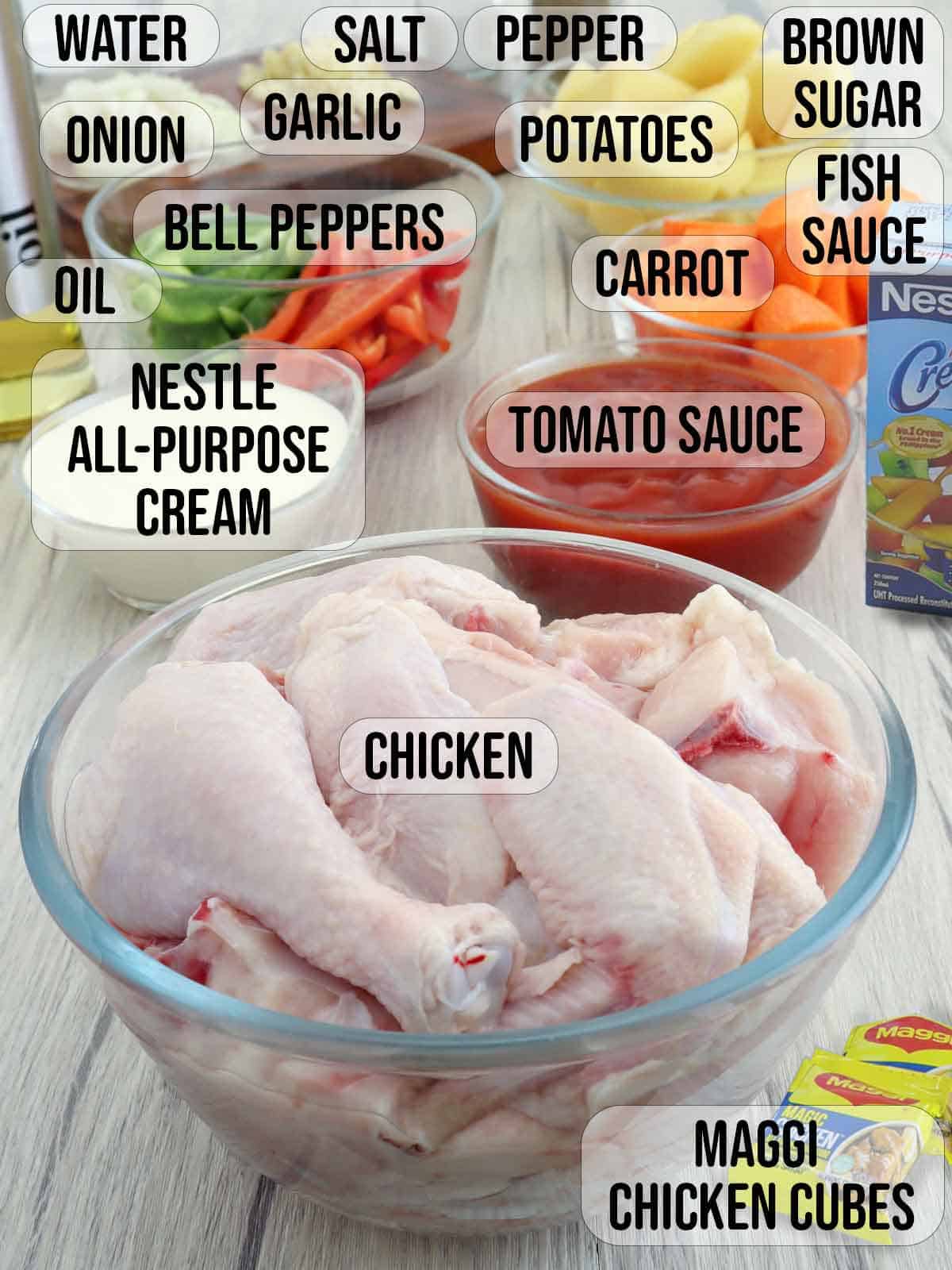 chicken, potatoes, carrots, all-purpose cream, bell peppers, onions, garlic, salt, pepper, Maggi chicken cubes, oil in bowls.