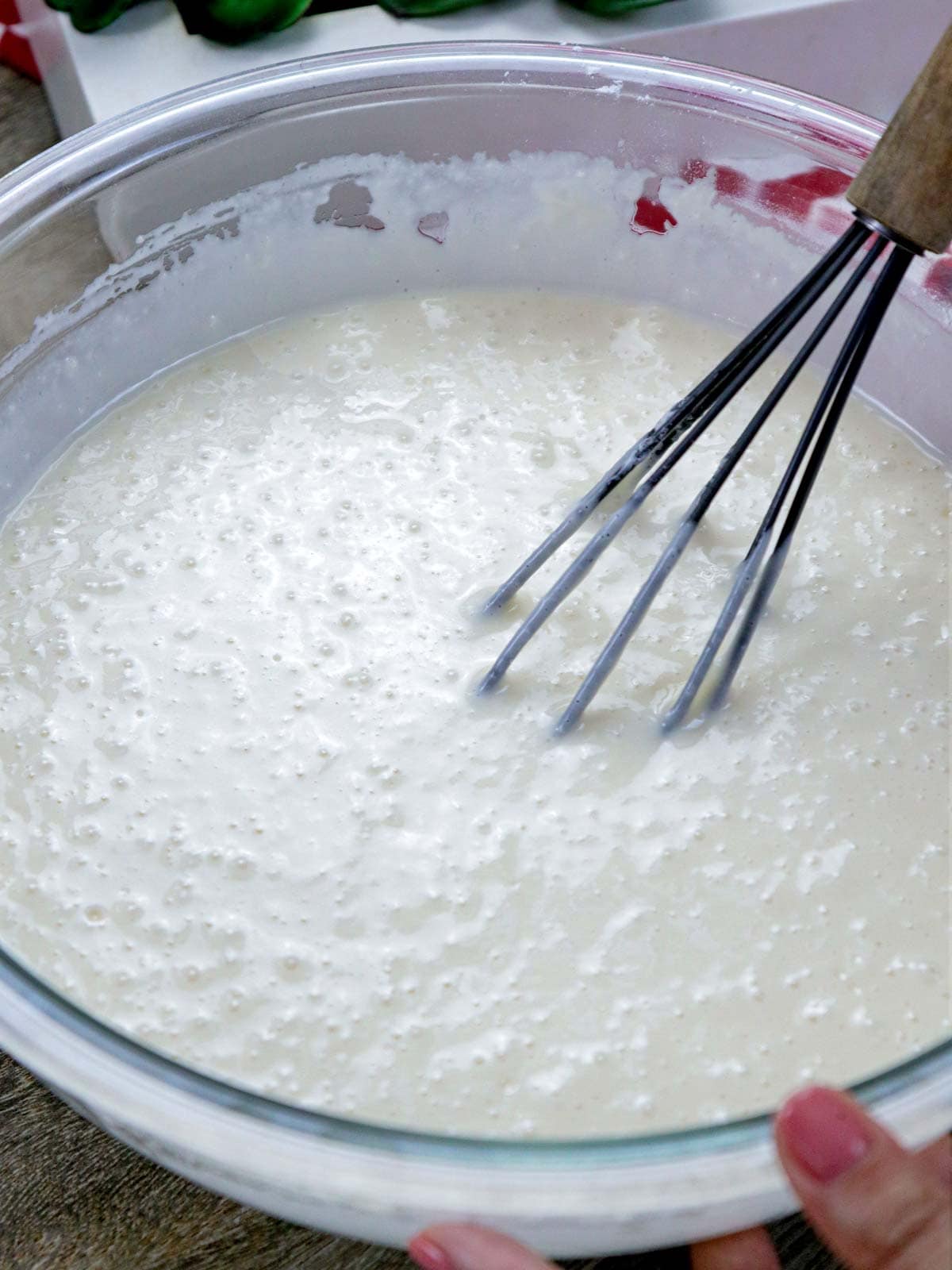 making bibingka pancakes in a bowl.